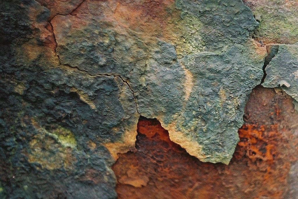 A close up of rust corrosion on a closed loop pipe surface
