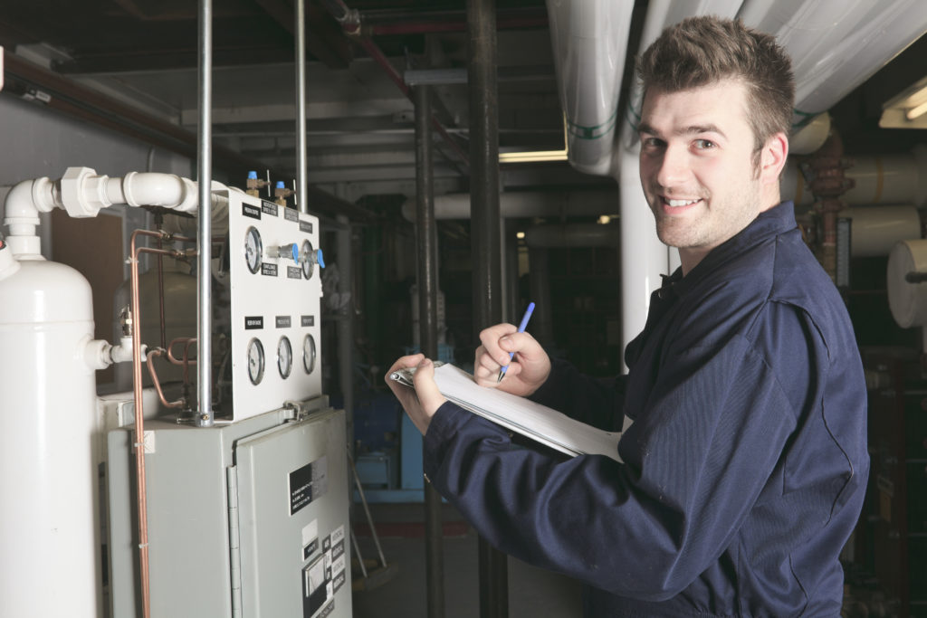 Service technician checking boiler system