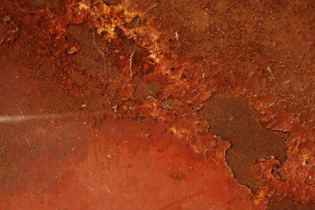Zoomed in orange rust with rough texture