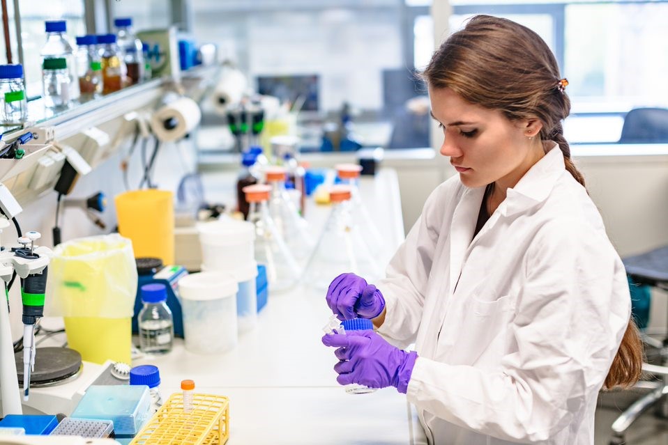 Girl in a laboratory examining a sample