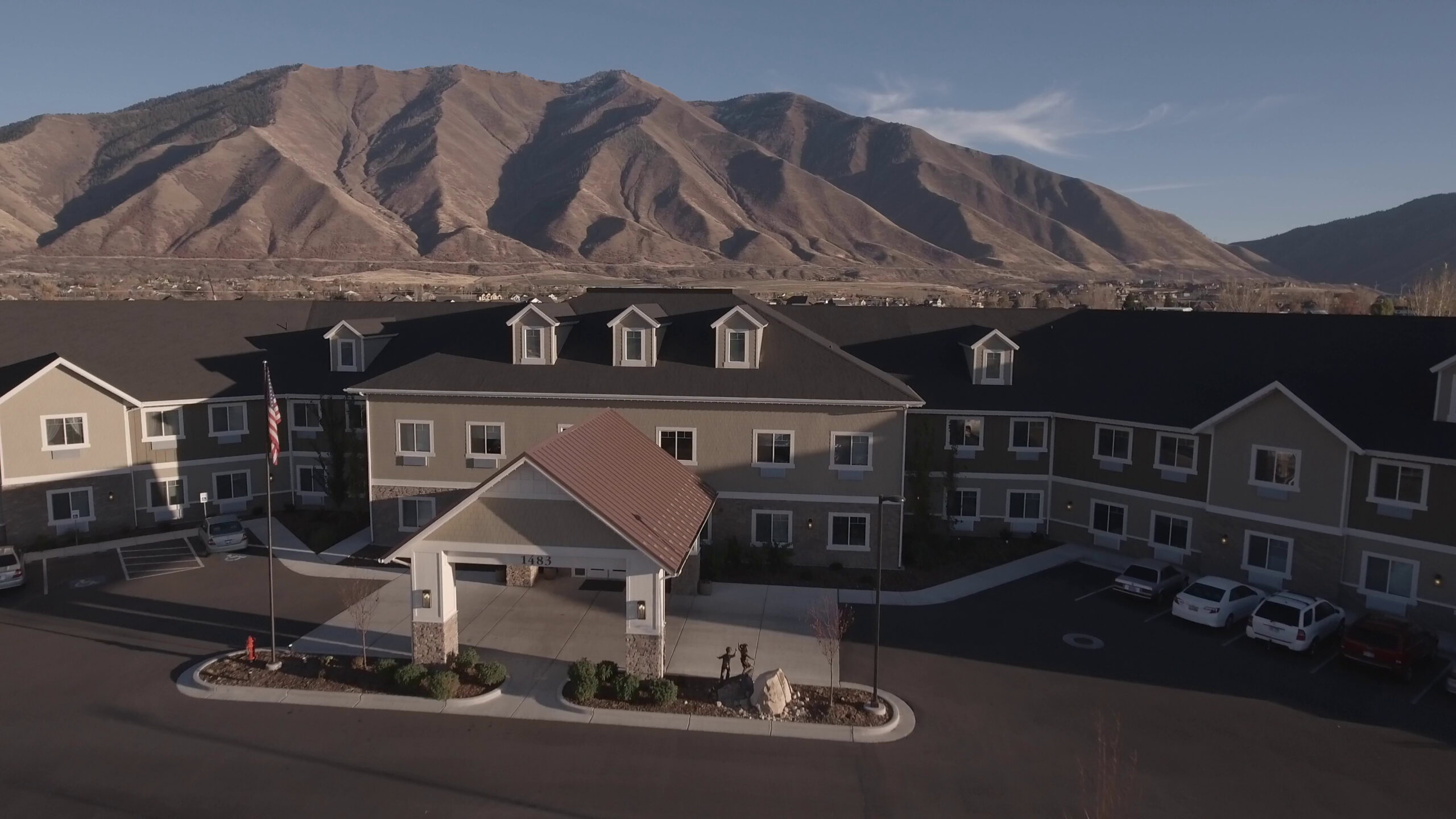 an-aerial-dolly-shot-of-retirement-home-by-the-mountains-in-city-SBI-350033190-scaled